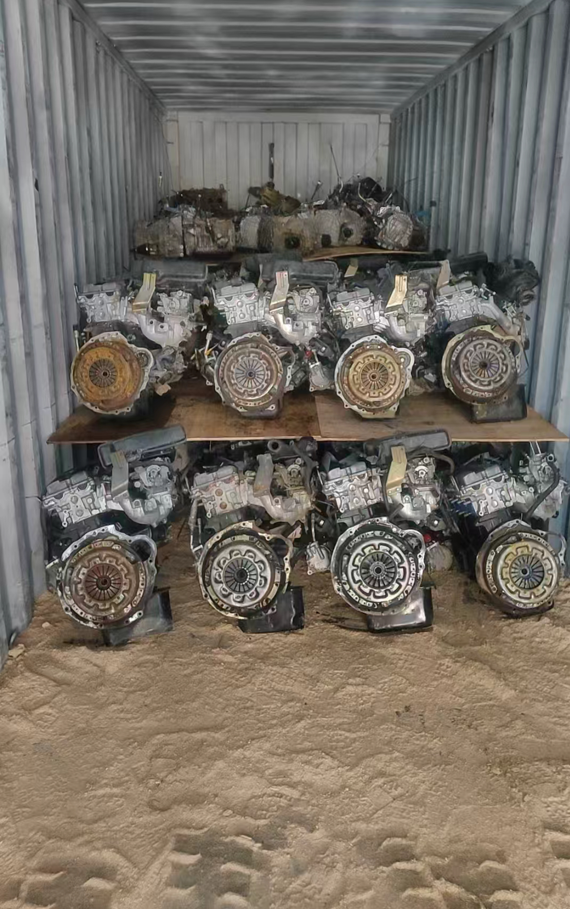Used engine assemblies arranged in a shipping container