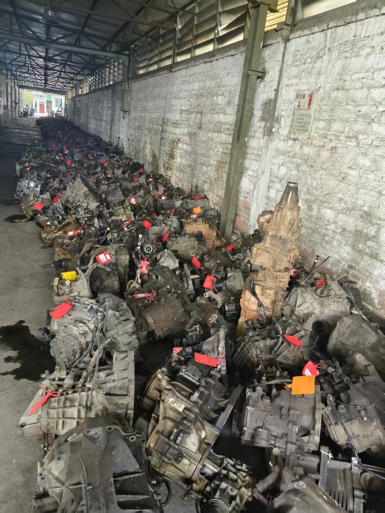 Tagged used engine and drivetrain units at a sourcing warehouse